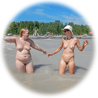 two women wade into the lovely waters