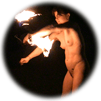 naked woman spinning fire at night