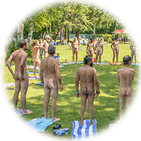 wide shot on lawn group of people stand in big circle