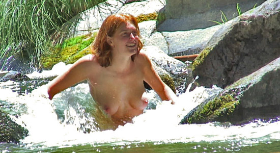 girl sitting in a waterfall nude